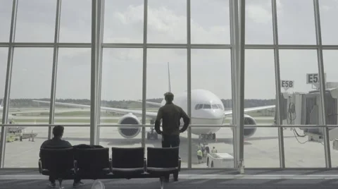 Model Stares at Airplane through Window Stock-Footage 56451811