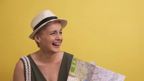 Model in straw hat with card in her hands on yellow background. Adult woman Stock Footage 142741589