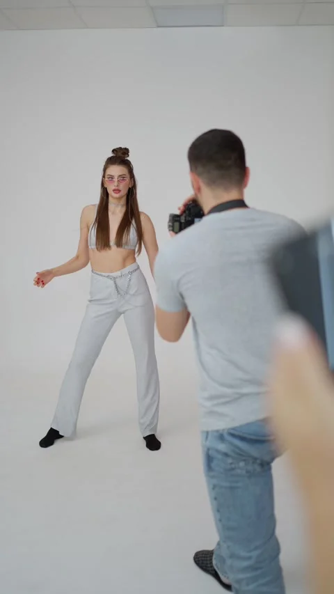 Model strikes energetic pose during professional photoshoot, highlighting joint Stock Footage 264929800