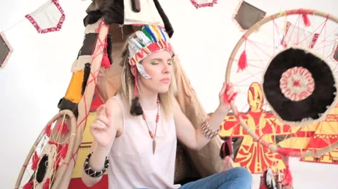 Model with tambourine dancing while sitting at wigwam 스톡 동영상 65368093