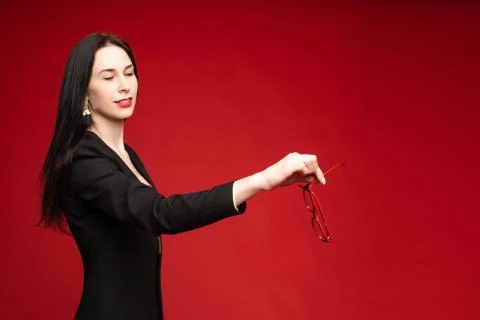 Model throwing her glasses away. Isolate on red. Foto stock