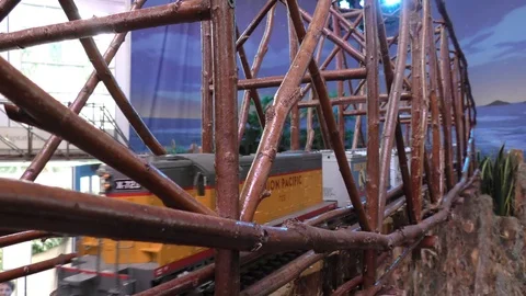 Model train across a trestle built from natural materials 4K Видео 93657647