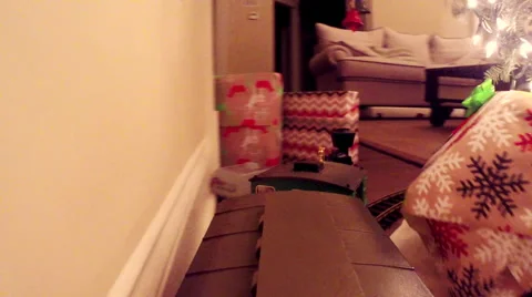 Model train circling a Christmas tree surrounded by presents Stock Footage 50617001