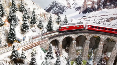 Model train in miniature passing on viaduct. Model railway Stock Footage 202132829