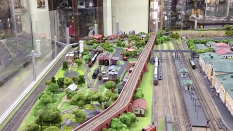 Model train set with a green bridge and a red train Stock Footage 301325210