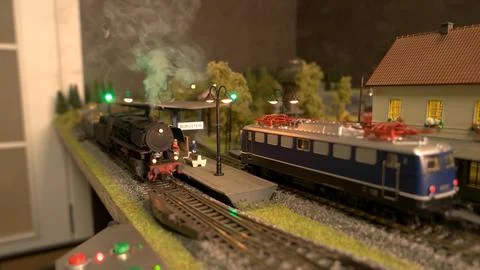 Model train with wagons is driving on model railroad. Stock Photos