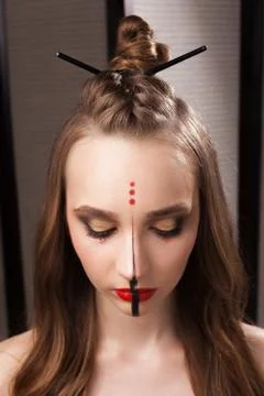 Model with unusual makeup and coiffure with closed eyes Stock Photos