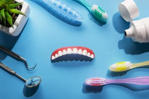 Model upper jaw prosthesis, toothpaste, toothbrush and dental tools Stock Photos