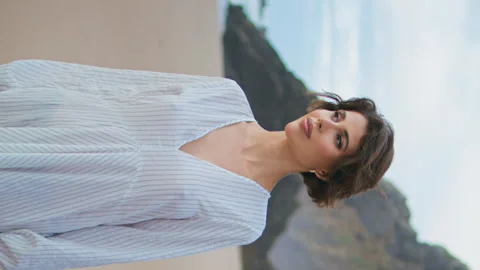 Model walking island shore on cloudy day vertically. Smiling traveler enjoying Stock Footage 275519526