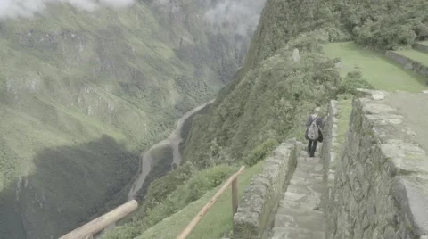 Model Walks Down Stairs Along River Valley in Machu Picchu Stock-Footage 56451829