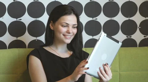 Model watching photos with a computer tablet Stock Footage 68447319