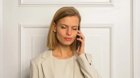 Model wearing business outfit while talking over her phone. Stock-Footage 103628832