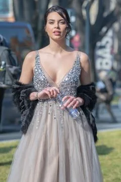 Model wearing a low-cut dress with silver sequins and a tulle skirt Stock Photos