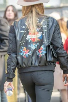 Model wears a black leather jacket with colorful decorations on the back Stock Photos