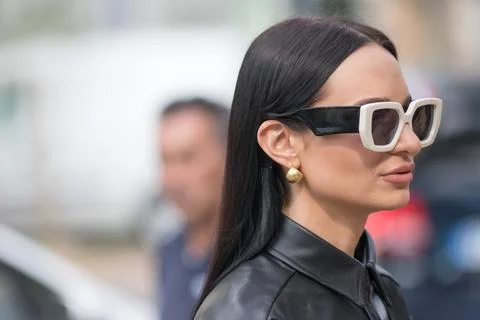 Model wears a black leather jacket and a pair of white-rimmed sunglasses Stock Photos