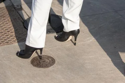 Model wears a pair of black leather shoes with a high heel Stock Photos