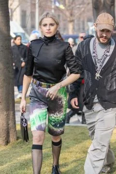 Model wears a pair of patterned shorts, a black shirt and black knee-high tights Stock Photos