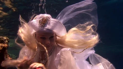 Model in white costume of pirate underwater in Red Sea Stock Footage