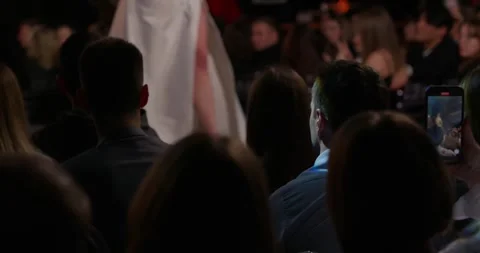 A model in a white dress walks down the catwalk showing off a new collection Stock Footage 272605531