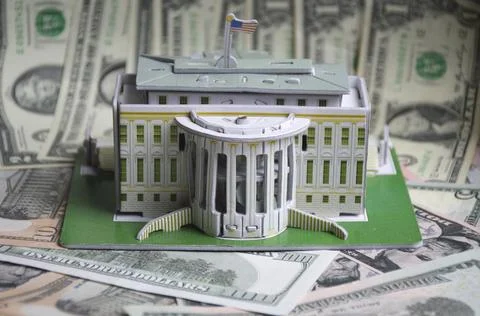 Model of a white house on the background of us dollars Stock Photos