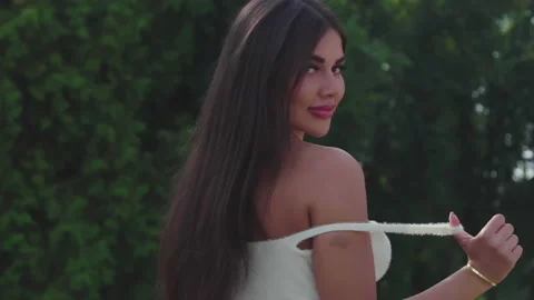 A model in white jeans.Takes off the strap and look Stock-Footage 157404945