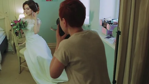 Model in white pose to photographer in studio Stock Footage 80043116