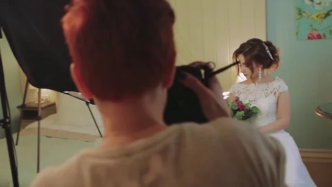 Model in white pose to photographer in studio Stock Footage 80240857