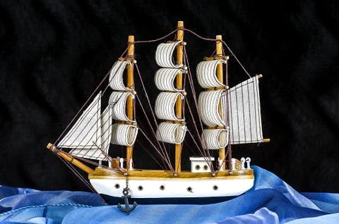 Model white sailboat with three masts on a black Stock Photos