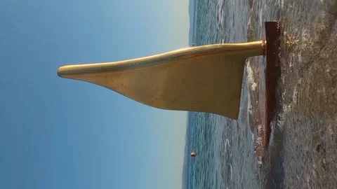 Model of yacht among the waves. Waves hit the yacht model in slow motion. Stock Footage 143951697