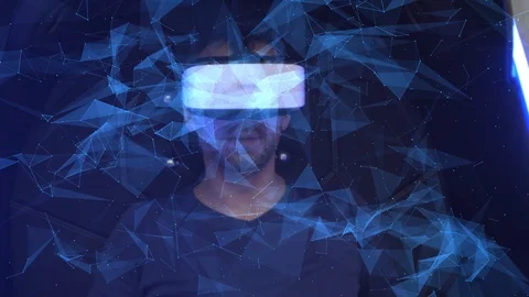 Model young man in glasses of virtual reality on dark background.. Augmented Video stock 128249627