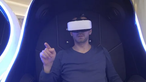 Model young man in glasses of virtual reality on dark background.. Augmented Video stock 128249714