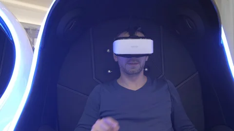 Model young man in glasses of virtual reality on dark background.. Augmented Stock Footage 128249736