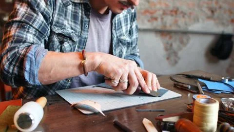 Modeling the design of a wallet, wallet to order. Workplace of a leather Stock Photos