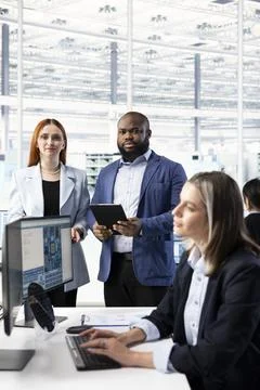 Modeling integrated circuit systems, PC and portrait of multiracial team Stock Photos