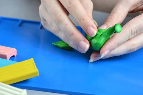 Modeling from multi-colored plasticine. Modeling board. Stock Photos