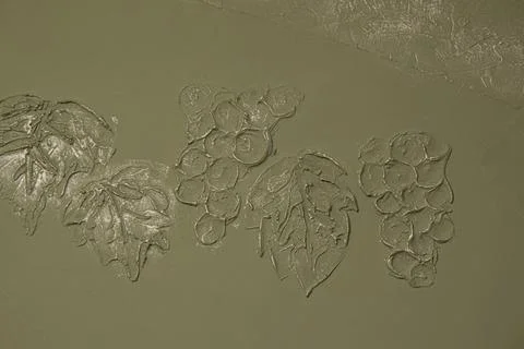 Modeling on the wall. Grapes pattern. Modeling grapes on the wall. Stock Photos