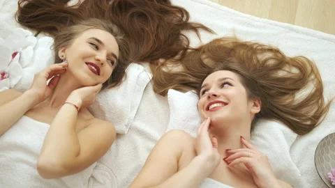Models of Caucasian appearance pose lying in front of the camera. Beautiful Stock Footage 138953142