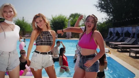 Models dance, twerk, sing and relax with alcohol cocktails at swimming pool Stock Footage 274333054