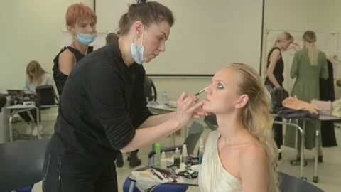 Models do a make-up and hairstyle before start the SEMILETOVA fashion show. Stock Footage 139308203