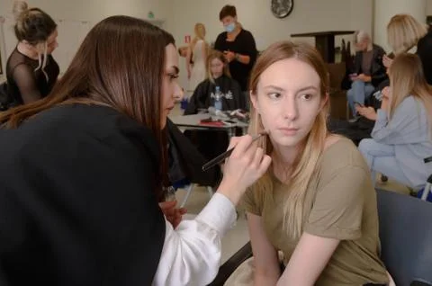 Models do a make-up and hairstyle before start the SEMILETOVA fashion show. Stock Photos