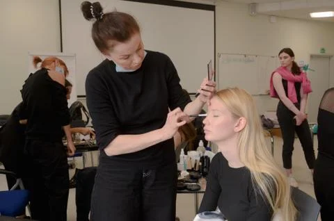Models do a make-up and hairstyle before start the SEMILETOVA fashion show. Stock Photos
