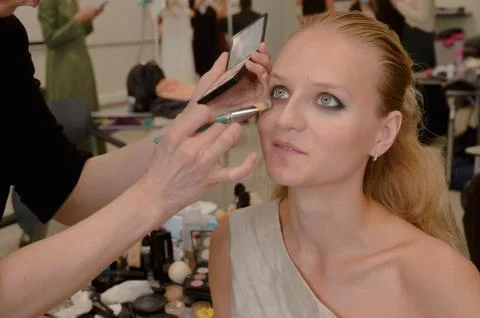 Models do a make-up and hairstyle before start the SEMILETOVA fashion show. Stock Photos