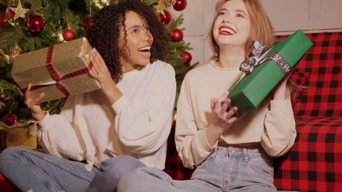 Models give each other gift near decorated Christmas tree at New Year eve Stock Footage 146132209