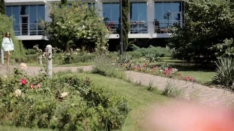 Models going one by one through the park in dresses Stock Footage 69158907