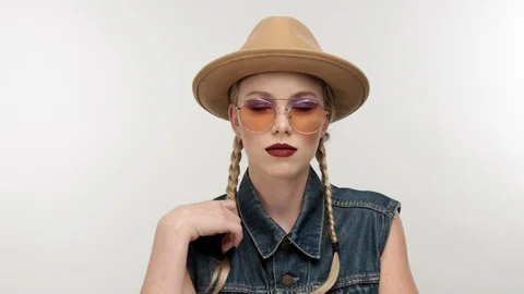 Models in hat with two braids and glassess, looks like a cowboy girl Stock Footage 97462038