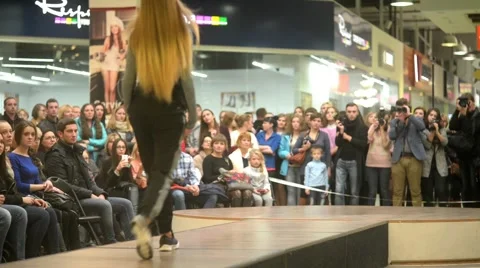 Models parade down catwalk podium - the audience watching a fashion show Stock-Footage 56730767