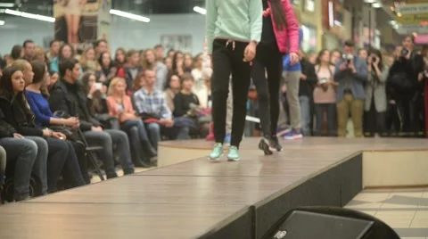 Models parade down catwalk podium - the audience watching a fashion show Stock-Footage 56730774