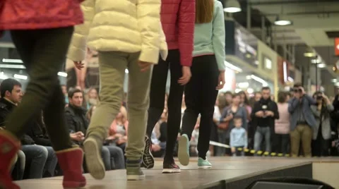 Models parade down catwalk podium - the audience watching a fashion show Stock-Footage 56730776
