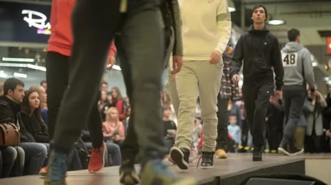 Models parade down catwalk podium - the audience watching a fashion show Stock-Footage 56730780