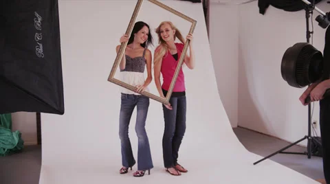 Models Play with Frame in Photo Shoot Video stock 35298262